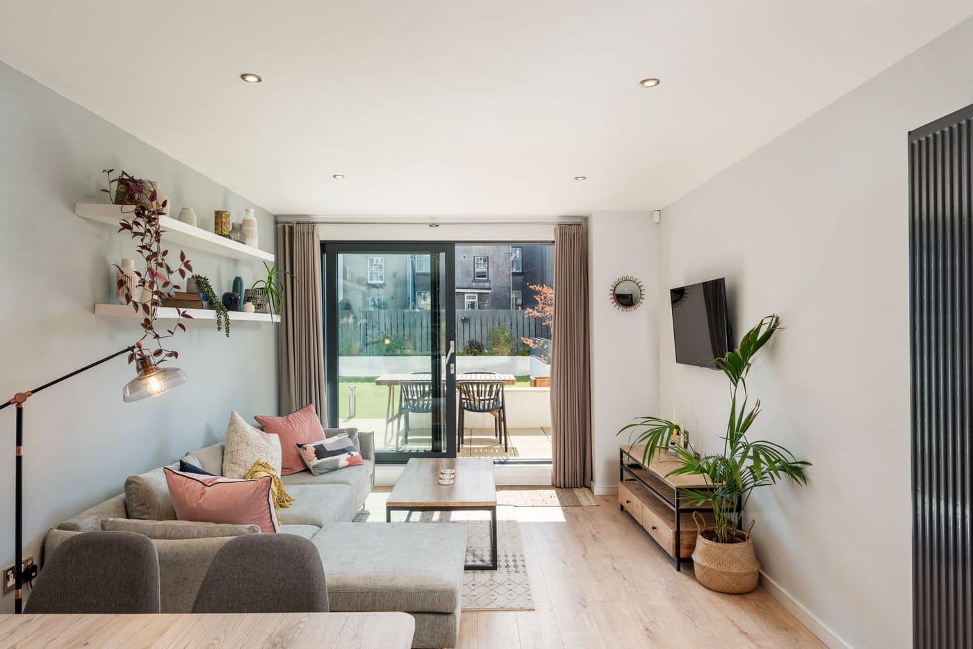 A bright apartment living room with sliding doors to a terrace.